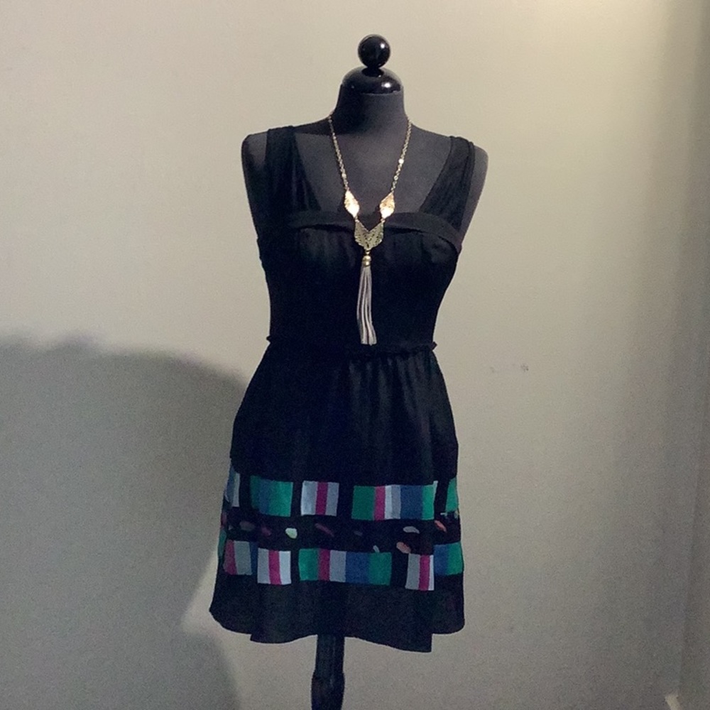 Black dress , jean jacket and necklace .